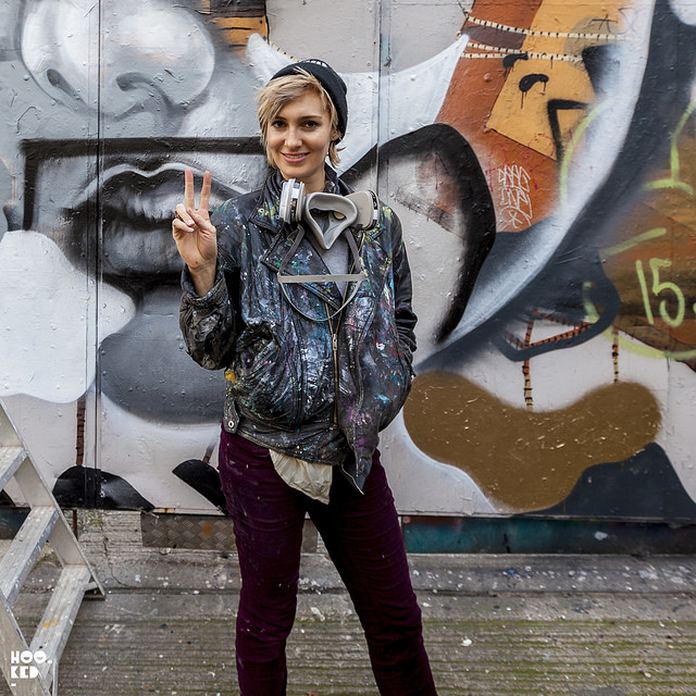 Elle poses in front of her London mural